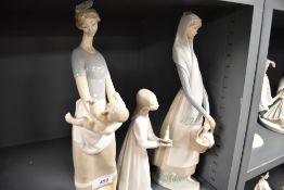 Three Lladro figure studies including Lady with backet, Girl in nightdress and Lady Holding nude