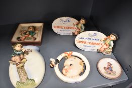 Two Goebel Hummel advertising plaques, a Ba Bee ring plaque, a wall pocket and a wall plaque.