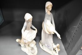 Two Lladro figurine studies including Girl with Rabbit and Lady with Goose and Dog.