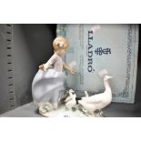 A Lladro figure group of a Girl feeding Geese No.5.503 with original box.