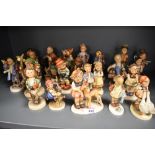 Twenty Two Goebel Hummel figures in varying poses and subjects, all in good condition.