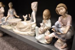 Six Lladro figure studies including Tramp boy resting, Girl with Bird, Woman with Washtub, Woman