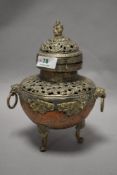 A 20th century Tibetan copper and white metal incense burner having raised relief and pierced