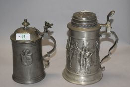 Two vintage pewter steins, one having hunting scene, the other a coat of arms.
