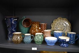 A large assortment of Schofield/Wetheriggs pottery, salt pig, vases, pie dish and jugs etc, some