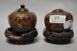 Two vintage Chinese cloisonné enamel lidded pots on carved wooden stands, having decoration of