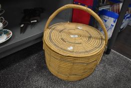 A vintage wicker basket with lid.