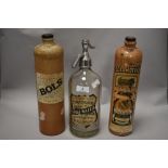 Three early 20th century bottles, two stoneware advertising bottles, one Bols, the other Genever and