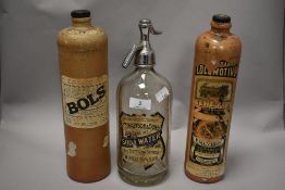 Three early 20th century bottles, two stoneware advertising bottles, one Bols, the other Genever and