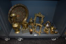 A mixed lot of brass ware, including early 20th century frames, toast rack, embossed charger and