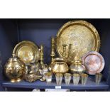 A selection of brass ware, including Indian Lassi cups, charger with traditional Indian scenes,
