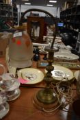 An early 20th century brass lamp on wooden base, having frosted glass shade with leaf decoration.