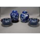 Two ginger jars, having cherry blossom decoration on blue ground, and two Japanese bowls.