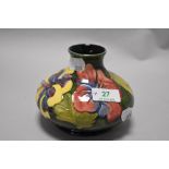 A mid century Moorcroft pottery Hibiscus pattern vase of squat form, having tube lined Hibiscus