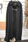 A vintage black wool cape, 'T Wippell and co, Exeter and Manchester'.