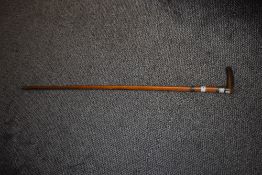 A Victorian walking cane, having hall marks for Birmingham, circa 1897/8 embossed cuff to neck and