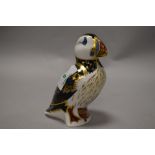 A Royal Crown Derby puffin paperweight, having gold coloured stopper.