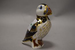 A Royal Crown Derby puffin paperweight, having gold coloured stopper.