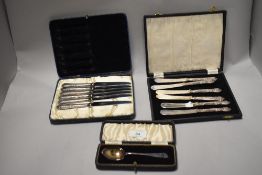 A selection of boxed vintage cutlery, including silver teaspoon hallmarked for Sheffield, and silver