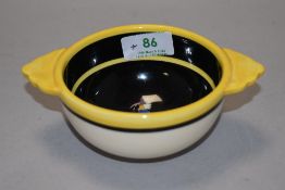 A small vintage Henriot Quimper French Folk Art hand painted ceramic bowl, having two handles.