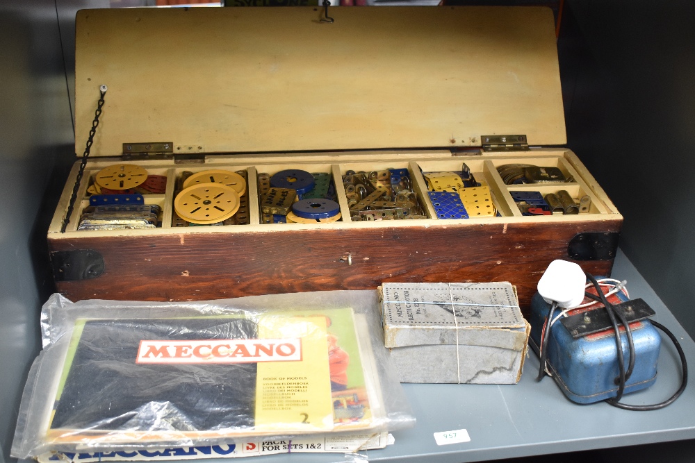 A wooden box of Meccano including Wheels, Pulleys etc, Meccano Electric Motor E20B. Instruction