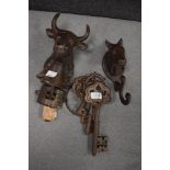 A vintage cast iron door bell in the form of a bull, a cast iron coat hook modelled as a horse,