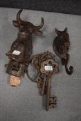 A vintage cast iron door bell in the form of a bull, a cast iron coat hook modelled as a horse,