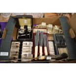 A box of assorted flat ware including fish knifes and forks, boxed cake forks, a boxed silver plated