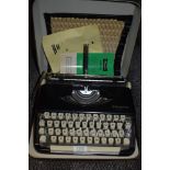 A cased Olympia Splendid 66 Typewriter.