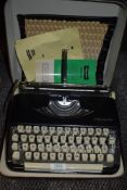 A cased Olympia Splendid 66 Typewriter.