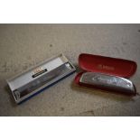 A vintage Hohner Educator II harmonica in original case and a Chinese Tower harmonica