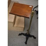 A Victorian music stand having mahogany stand with brass support and column on quadruple shaped cast