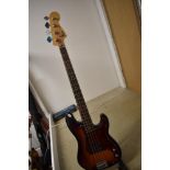 A Squier by Fender 'P' bass, with after market and original scratch plates, and padded gig bag