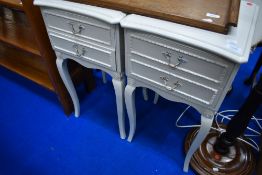 A pair of French style painted bedside drawers