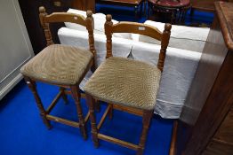 A pair of vintage pine bar stools
