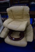A Stressless easy chair and matching footstool, in mustard
