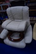 A Stressless easy chair and matching footstool, in cream