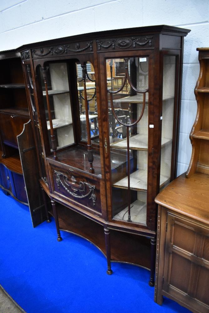 An early 20th Century mahogany display cabinet having central mirror , and drop flap cocktail