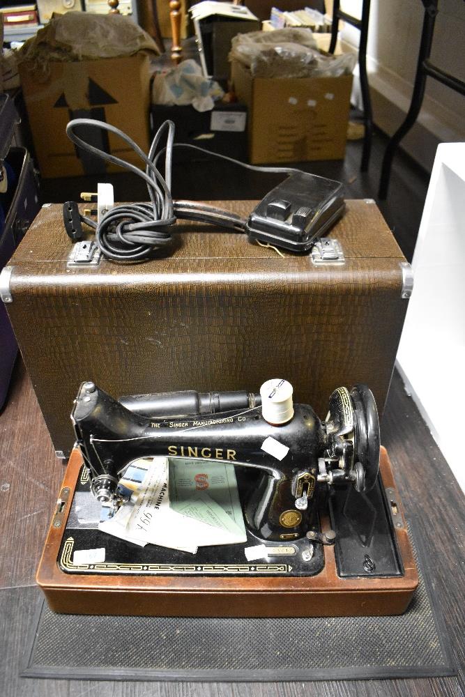 A 20th century electric Singer Sewing machine 99k with original case, accessories and manuals.