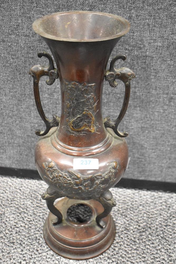 A Japanese Meiji era bronze cast incense burner on a lion headed tripod base with cast bird and