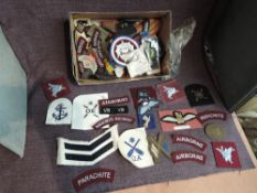 A box of Parachute and Glider Regiment Cloth Badges including Wings also Kings Own, Royal Marines