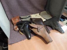 A box containing eight Pistol Holsters, five leather and three canvas