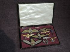 A small folding case containing Air Force cloth & metal badges including Sweethearts, German WW2