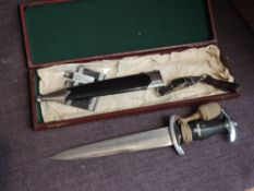 A German WW2 SS Officers Dagger 1936 having blackened handle, black scabbard, Portepee Knot and