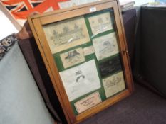A wooden and glazed display case containing Gum Makers Labels including Holland & Holland, Adams,