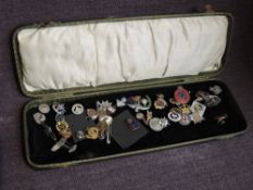 A collection of Badges and Sweetheart Brooches, mainly Military in a folding case