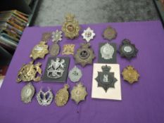 A collection of British Helmet Plates and Large Cap Badges including Royal Lancaster, Argyll &
