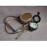 A Francis Barker M73 Military Compass having military marks and leather case marked 83PG