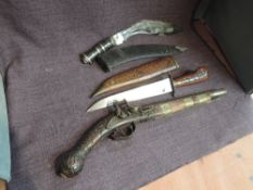 A reproduction Flintlock Pistol along with a chromed bladed Kukri in wood and leather scabbard and a