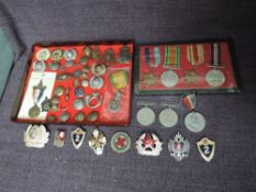 A collection of Militaria including WW2 Medals, modern Russian Badges and a display of Badges and